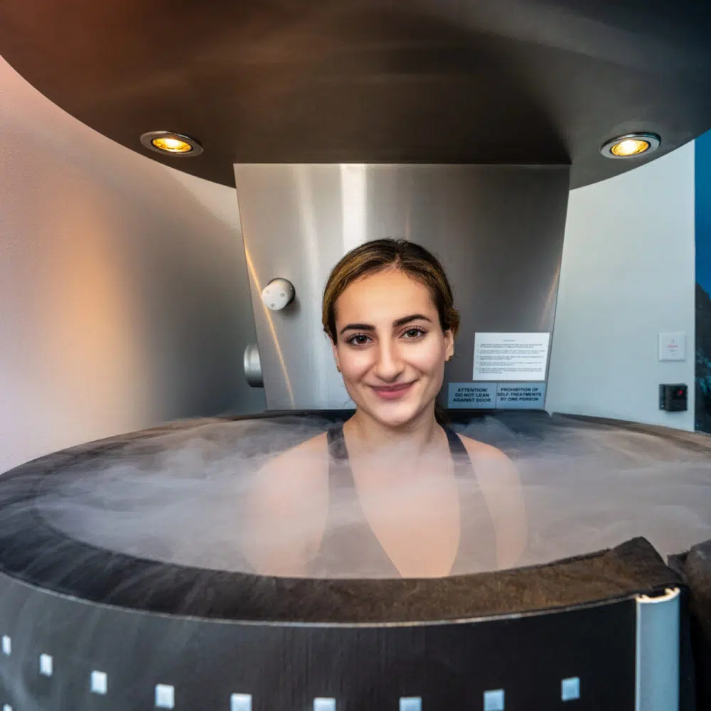 Woman smiling ready for cryotherapy treatment.