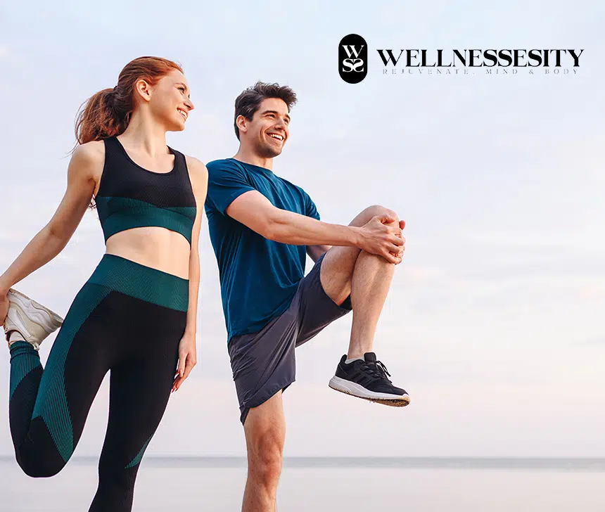 Athletic couple stretch their legs during a run to model the benefits of compression therapy in New Jersey at Wellnessesity for the hero image of the page.